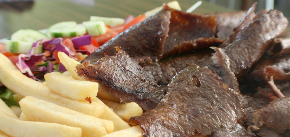 Doner kebab cut from a huge turning spit