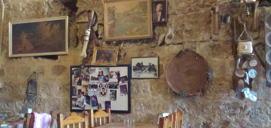 The walls are decorated with old musical instruments and farming tools