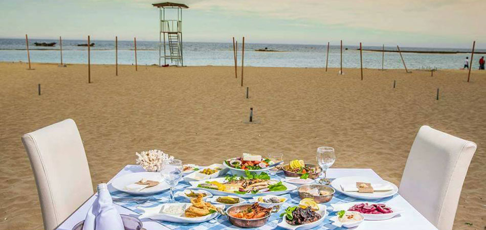 Fish mezes on a table laid out on the beach