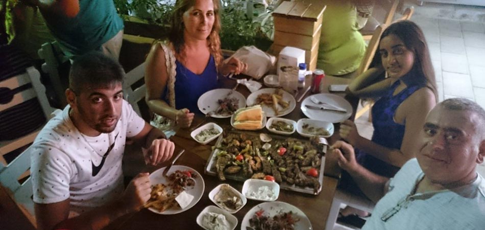 Friends share a huge plate of meat and kebabs